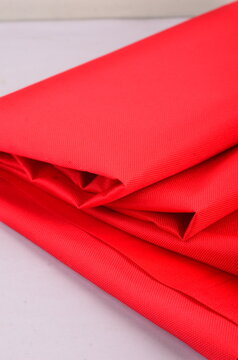 JAKARTA, INDONESIA - JANUARY 6, 2026: Close-up of vibrant red ripstop triumph fabric, used for high-visibility safety and tactical gear.