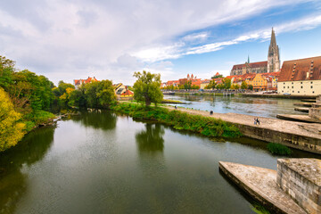 The skyline of medieval Regensburg, Germany seen from the Steinerne Brücke bridge on the Danube River.