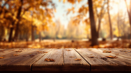 A wooden surface with scattered autumn leaves in a blurred forest setting