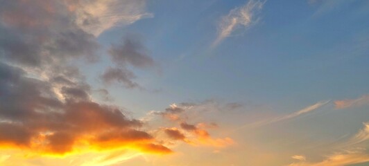 Panorama sunrise sky with vibrant colorful clouds. Beautiful early morning sky in wide landscape view. Sunrise and clouds in the morning.