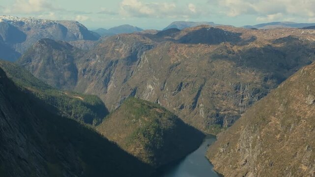 Cinematic drone shot revealing the vast alpine landscape of Matrefjellene in spring