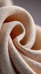 Close-up of a pale beige fabric swirled into a spiral