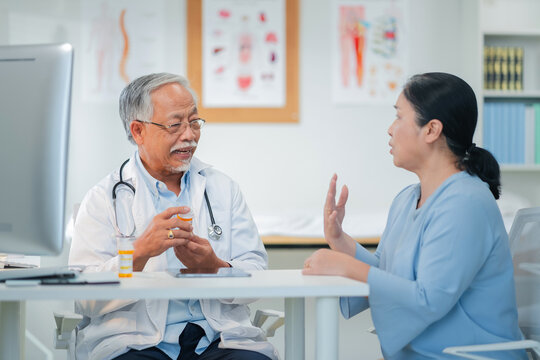 Male senior doctor discusses personalized medicine treatment with female patient hospital. Integrative healthcare approach combines conventional therapy with alternative medicine for holistic patient