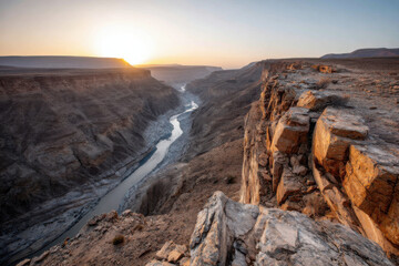Obraz premium Drone shot of winding desert canyon at sunset