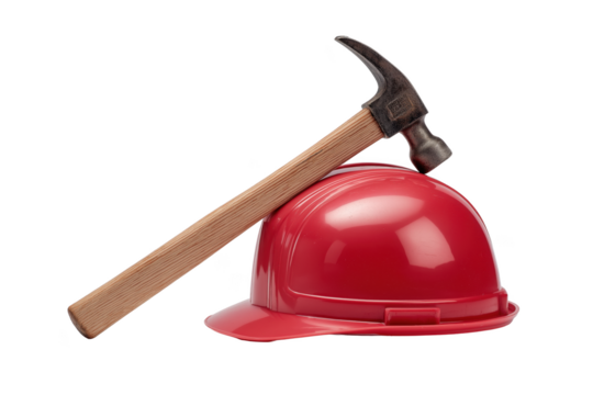 Red hard hat and hammer symbolizing construction safety and labor in a studio setting transparent background
