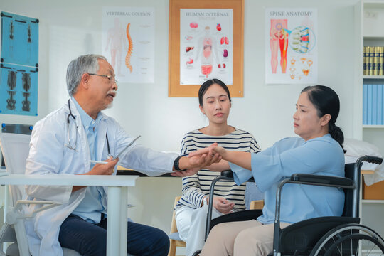 Asian daughter accompanies senior mother for medical consultation with doctor using digital health technology. Family centered care demonstrates intergenerational support and patient advocacy through