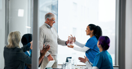 Award, doctors and thank you with people in meeting for healthcare breakthrough, research grant and prize. Medical milestone, applause and support with nurses in hospital boardroom for trophy