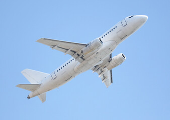 A white airplane is flying in the sky