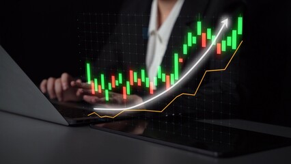 A business professional focuses on a laptop with a financial growth graph overlay, indicating positive trends and market analysis. Ideal for finance and business themes. Copula