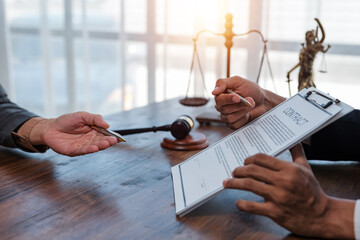 Lawyers are discussing contract terms and conditions in a meeting, with legal documents and a gavel...