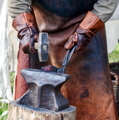 Man is hammering a piece of metal