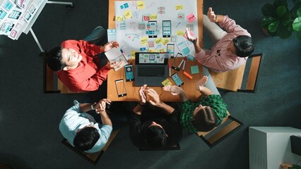 Top view of project manager using laptop working on Ux Ui design for mobile phone interface while...