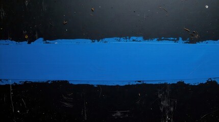Naklejka premium A vibrant blue stripe of paint dramatically contrasts against a dark, textured background, creating a striking visual effect that is both simple and bold.