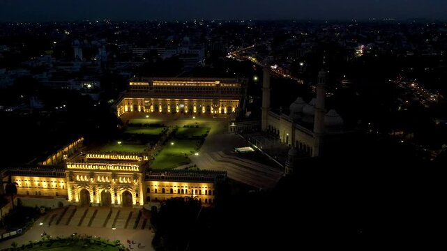 Aerial drone shot of lucknow building bada imambada  mosque with night lights  road at night with cars