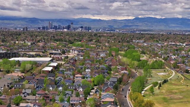 Front Range Denver Lowry Northfield Central Park Colorado aerial drone summer spring green blossom neighborhood condo apartment buildings sunny cloudy sky cars cityscape skyscrapers parallax right