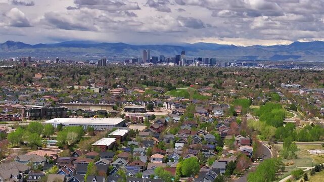 Front Range Denver Lowry Northfield Central Park neighborhood apartment buildings Colorado aerial drone sunny cloudy sky cloudy Lakewood Arvada Golden cars cityscape skyscrapers forward up motion