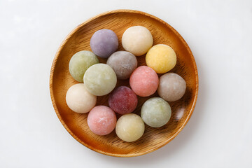 colored ball shaper rice cakes in various colors on wooden plate, korean traditional Chuseok Day festival day concept