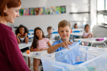 Young children learning about sustainability and ecology, sorting waste.