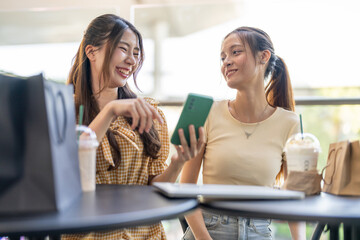 Woman holding smartphone browsing summer sale searching for deals at fashion store, shopping lifestyle at modern mall, online shopping, e-commerce, discount season, customer enjoy digital technology