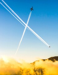 Two planes cross paths in the sky