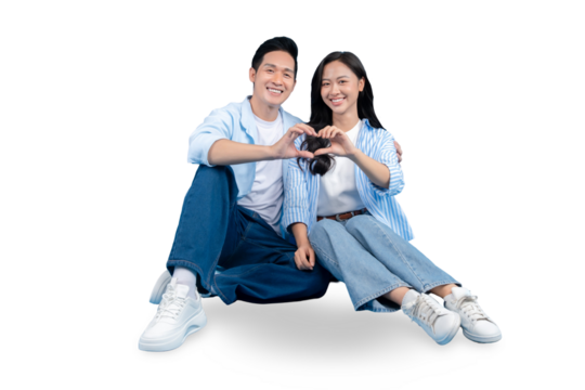 A loving couple sitting together making a heart gesture on PNG background