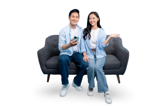 A cheerful couple on a comfortable gray sofa holding a phone and smiling against a clean background. The scene captures the modern lifestyle and ease of communication. 