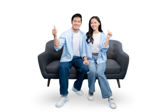 A couple sitting on a couch, smiling and giving a thumbs up on PNG background