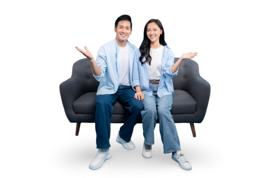 Smiling couple sitting on sofa with open arms. A happy couple is posing on the gray couch in front of PNG background