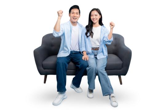 Happy couple joyfully celebrating on sofa on PNG background