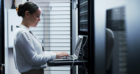 Laptop, typing and woman in server room for cybersecurity, network maintenance or programming. Administration, computer and firewall installation with IT professional in data center for engineering