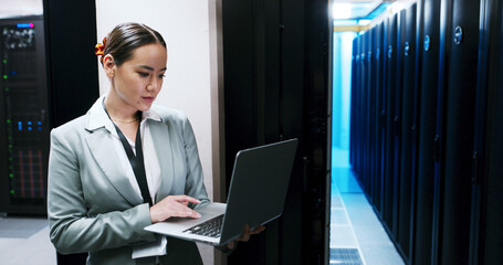 Administration, laptop and woman in server room for cybersecurity, network maintenance or programming. Computer, firewall installation and typing with IT professional in data center for engineering