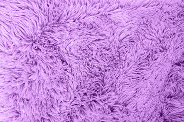A close-up shot revealing the soft, textured surface of a vibrant purple fabric.
