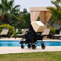 A beige and black wheelchair sits poolside, facing away, under a canopy