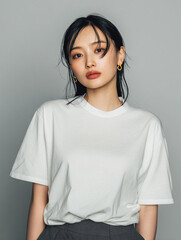 Fototapeta premium A beautiful female model wearing a white t-shirt. A product shot for fashion and apparel. best use for mockup.
