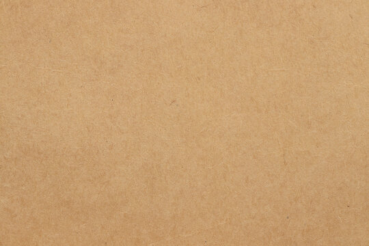Brown cardboard sheet abstract background, texture of sepia color kraft paper with vintage pattern for design art work.