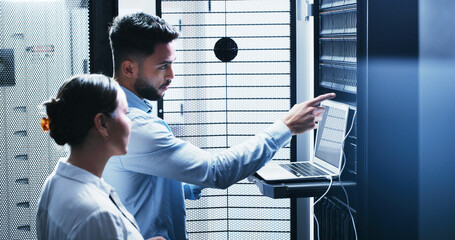 Collaboration, laptop and problem solving with people in server room for network administration. Computer, conversation and cybersecurity with IT support team in data center for troubleshooting