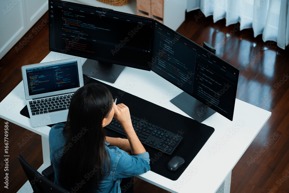 Wall mural top view young asian it developer creating with typing online information on pc with coding program 