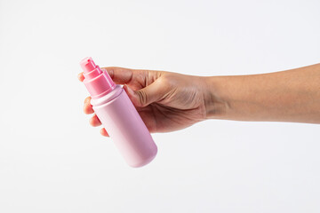 Pink product bottle in hand on white background