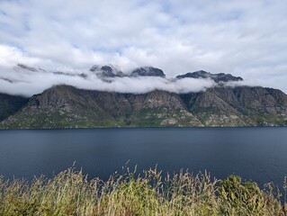 Misty mountains over lake, New Zealand