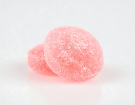 Two round, pink, sugary candies