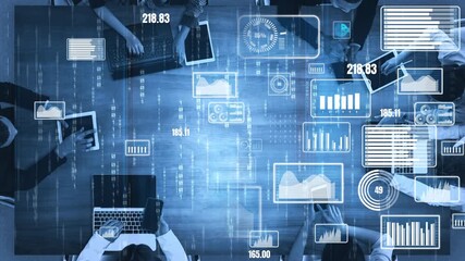 Aerial view of a business meeting showcasing digital analytics and data visualizations. Diverse professionals collaborate actively around a table with technology. Xenic - Powered by Adobe