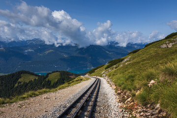 Schafbergbahn cog railway riding on top of mountain Schafberg. Tourist attraction