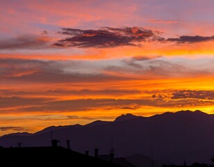 Vibrant sky over mountain range during sunrise or sunset time of day