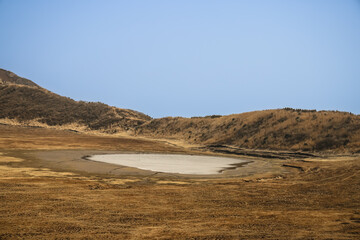 March 25 2025 Landscape of a Dry Lake Surrounded by Golden Grass and Hills, Japan