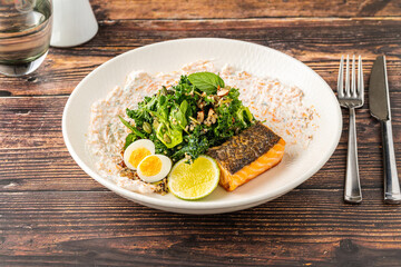 Fresh grilled salmon with greens, eggs, and creamy dressing