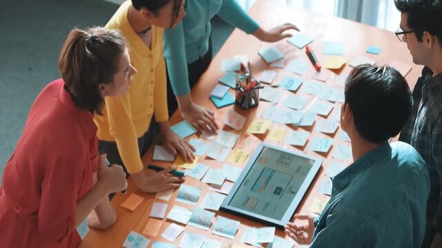 Top view of skilled programmer brainstorming idea about mobile phone interface while develop app development by using wireframe prototype. Web designer planning at table with sticky notes. Symposium.