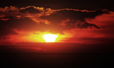 Image of dramatic twilight sky look like atomic bomb with bright light fire and hot atmosphere shape by clouds and bright sun. Image use for environmental presentation background.