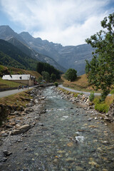 Visitors stroll along the scenic paths of Cirque de Gavarnie, surrounded by majestic mountains and...