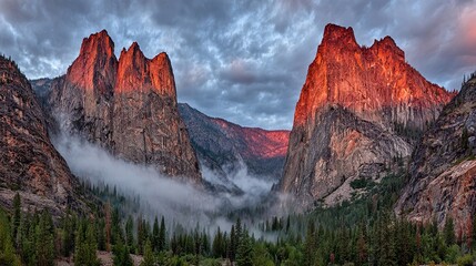 Majestic granite cliffs with sunset glow and misty valley forest