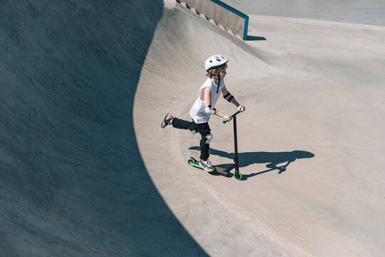 Young Scooter Rider in Skatepark Performing Tricks and Showing Off